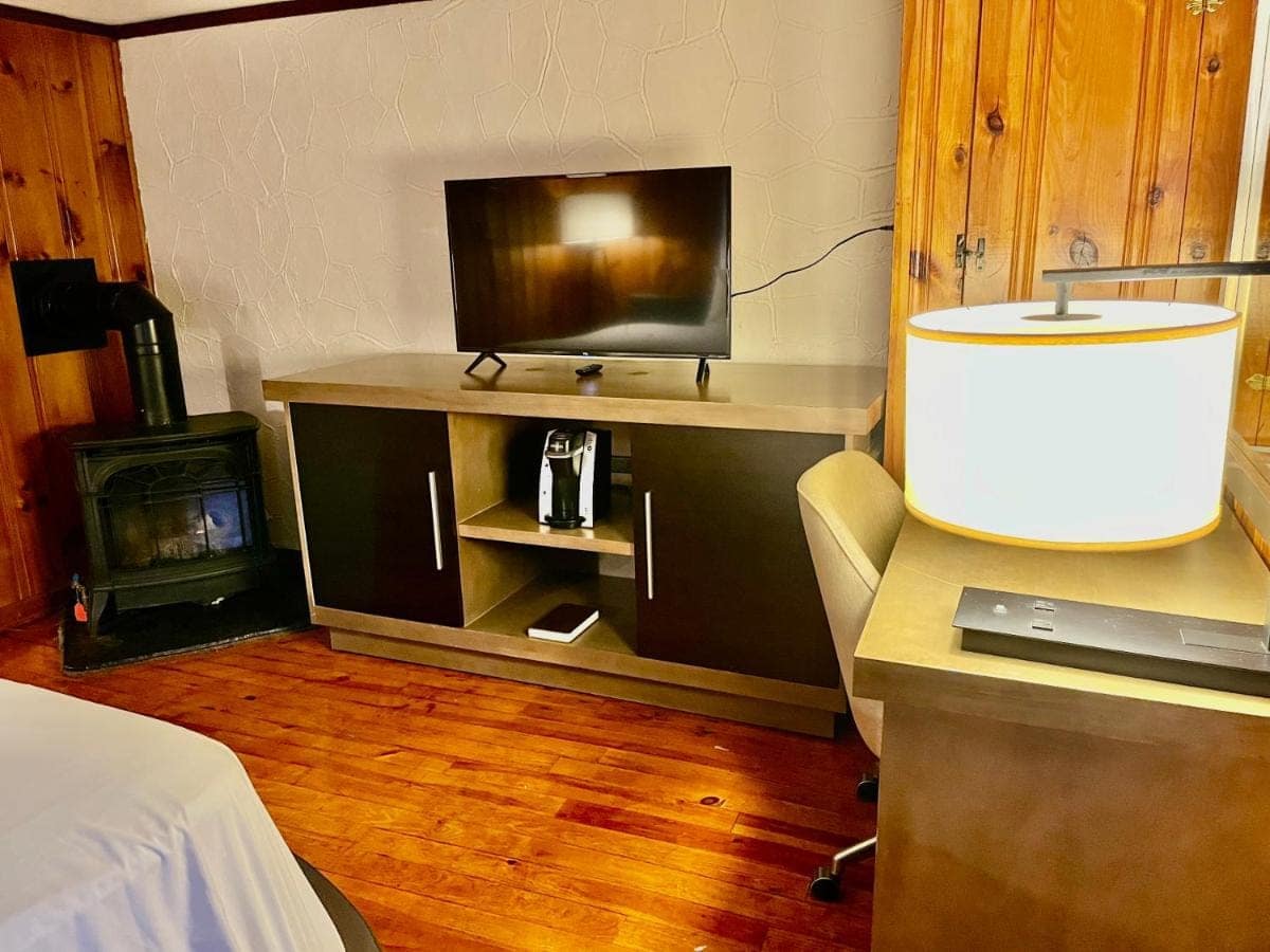 Bedroom with a coffee maker, flat-screen TV and gas stove