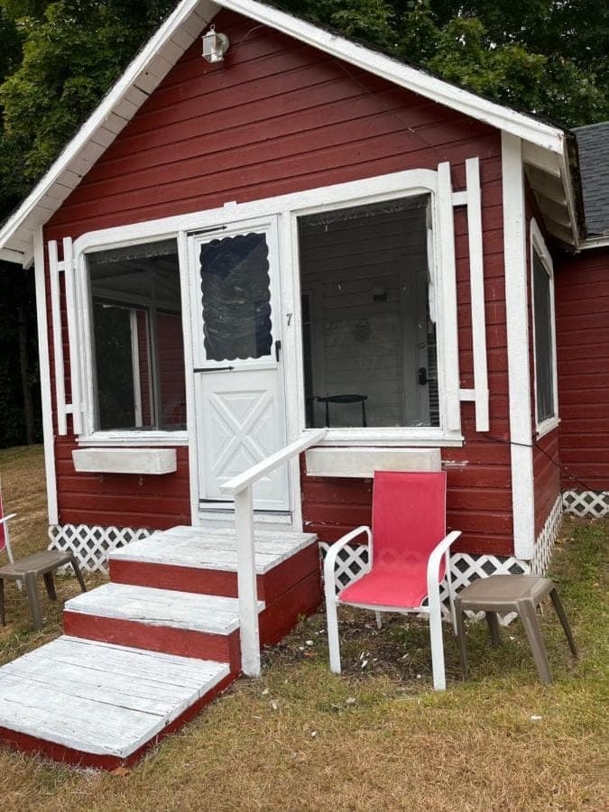 Cabin seven with a screened porch and a chair out front