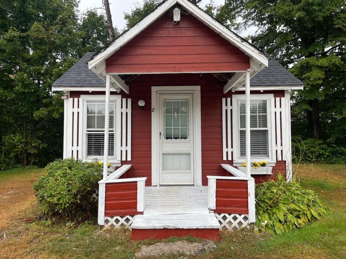 Cabin eight with window boxes and a white painted porch