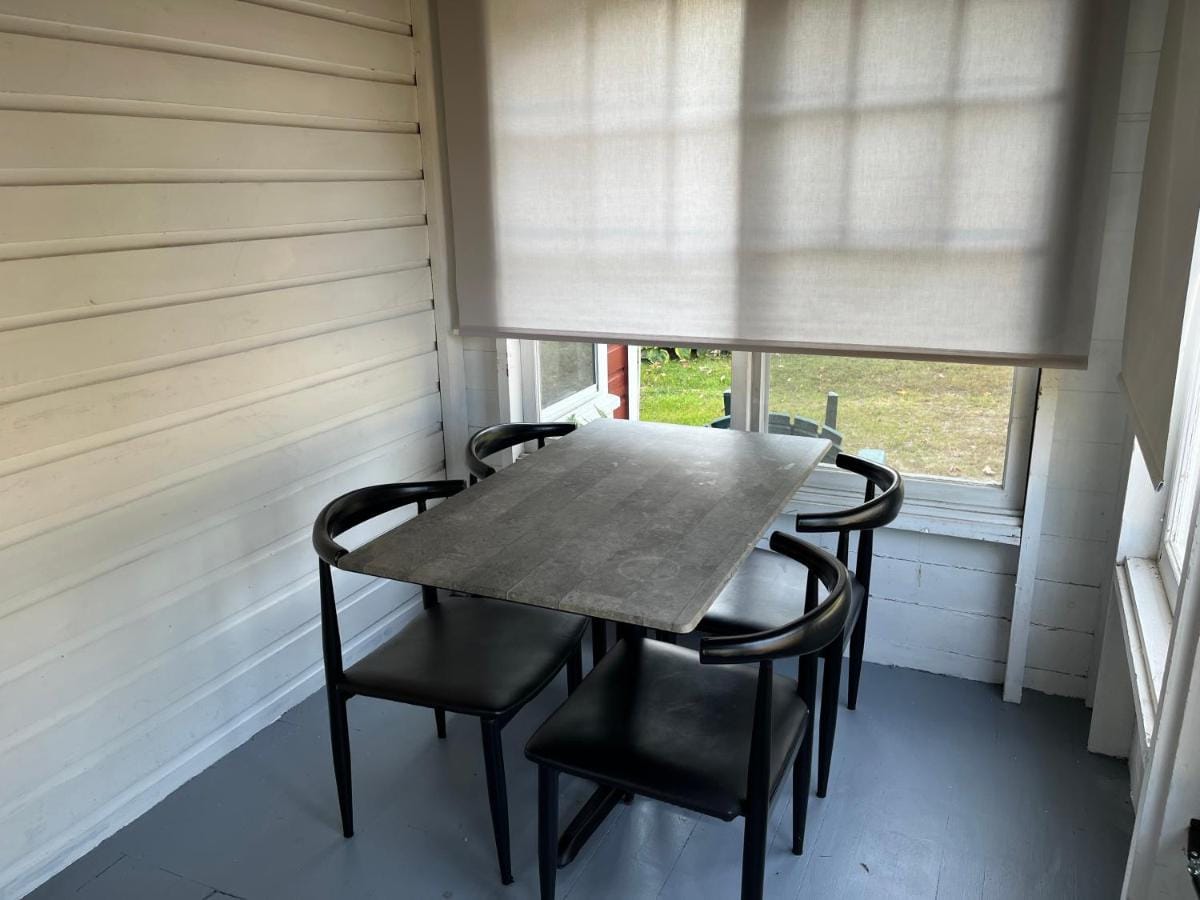 Screened porch with a dining table for four